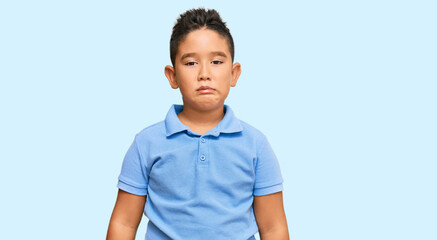 Little boy hispanic kid wearing casual clothes depressed and worry for distress, crying angry and afraid. sad expression.