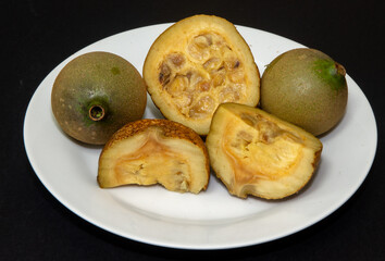 Ripe Jenipapos, fruits cut in half showing their interior, Fruit typical of Brazil