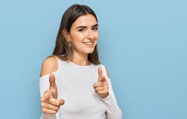 Young hispanic woman wearing casual clothes pointing fingers to camera with happy and funny face. good energy and vibes.