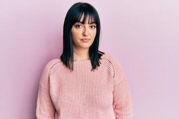 Fototapeta premium Young hispanic woman wearing casual clothes with serious expression on face. simple and natural looking at the camera.