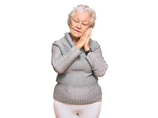 Senior grey-haired woman wearing casual winter sweater sleeping tired dreaming and posing with...
