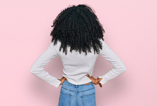 Young african american girl wearing casual clothes standing backwards looking away with arms on body