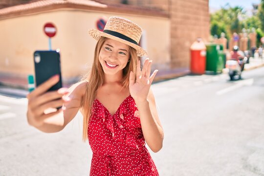 Young caucasian tourist girl smiling happy doing video call using smartphone at the city.