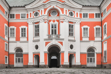 The facade of the monastery in Broumov with numerous windows and decorations.