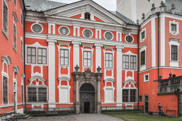 The facade of the monastery in Broumov with numerous windows and decorations.