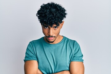Young arab handsome man wearing casual clothes skeptic and nervous, disapproving expression on face with crossed arms. negative person.