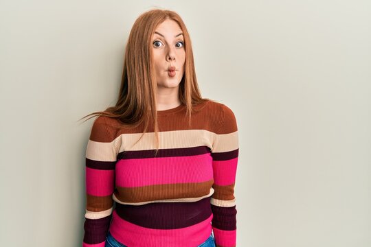 Young irish woman wearing casual clothes making fish face with lips, crazy and comical gesture. funny expression.
