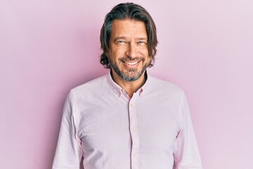 Middle age handsome man wearing business shirt looking positive and happy standing and smiling with...