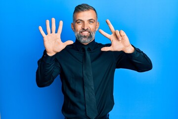 Fototapeta premium Middle age handsome man wearing business shirt and tie showing and pointing up with fingers number eight while smiling confident and happy.