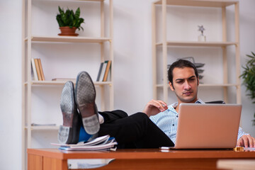 Young male employee sitting in the office