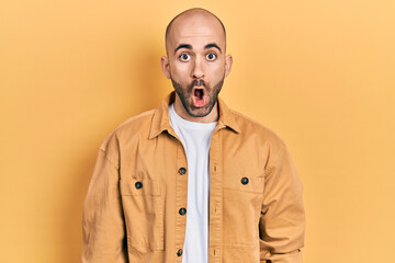 Young bald man wearing casual clothes scared and amazed with open mouth for surprise, disbelief face