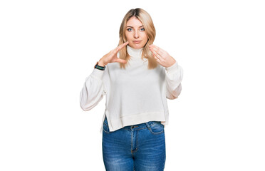 Young caucasian woman wearing casual winter sweater doing frame using hands palms and fingers, camera perspective