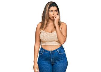 Fototapeta premium Beautiful brunette woman wearing casual clothes looking stressed and nervous with hands on mouth biting nails. anxiety problem.