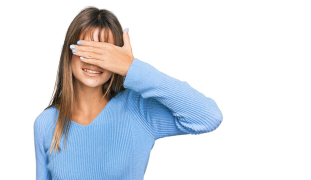 Teenager caucasian girl wearing casual clothes smiling and laughing with hand on face covering eyes for surprise. blind concept.