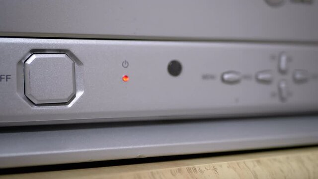 Female Fingers Pressing Power Button on An Old, Silver, Grey TV. Dashboard. 4K