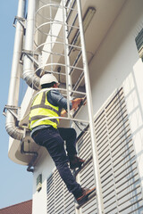 The technician works at heights with safety of Construction worker use safety harness and safety line working,maintainance checking facility.