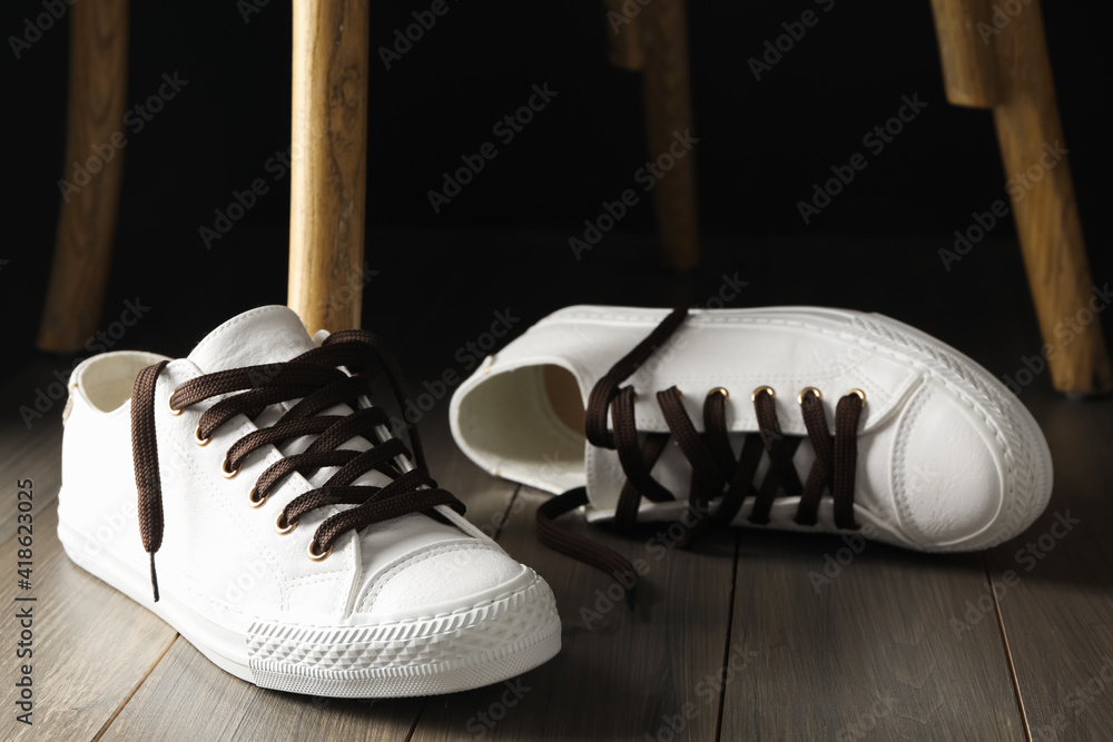 Canvas Prints Pair of stylish shoes with brown laces on wooden floor indoors