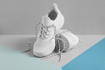 Pair of stylish shoes with laces on color background - obrazy, fototapety, plakaty