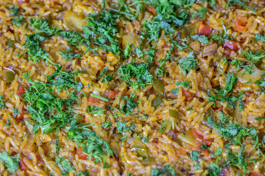 View of Biryani (also known as biriyani, biriani, birani or briyani).Biryani garnished with coriander leaves is a mixed rice dish originating among the Muslims of the Indian subcontinent.