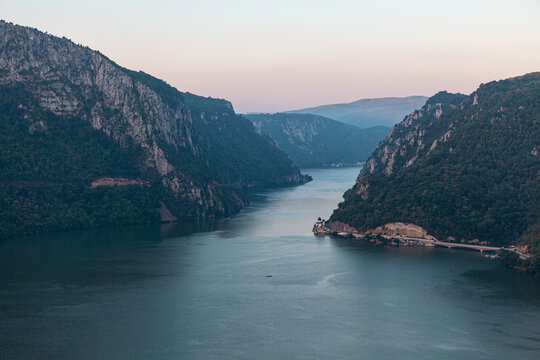 High cliffs along the Danube river . High cliffs along the Danube river . Cazanele Dunarii Spectacular Mountains and River . Border between Serbia and Romania