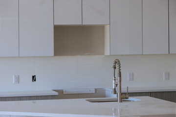 New modern white kitchen with built chrome water tap