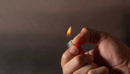 Hand holding lighting lighter