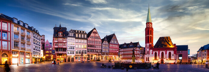 Panorama of the Römerberg in Frankfurt am Main with illuminated buildings at sunset