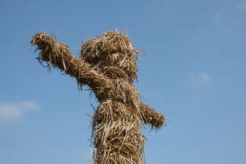 Scarecrow soars into blue sky
