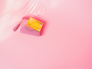 shopping and payment concept from pink wallet with credit cards or discount card on pink background.