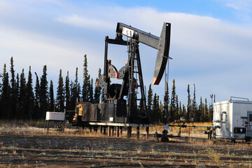 Stilled oil rigs with closed radigans signage