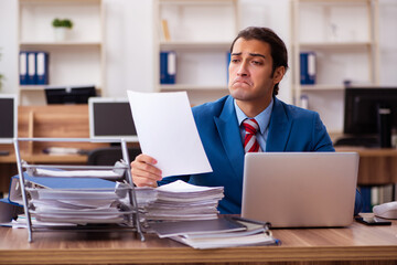 Young male employee working in the office