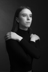 portrait of a young beautiful woman in a studio in dark colors