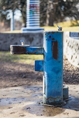 blue water fountain on trail