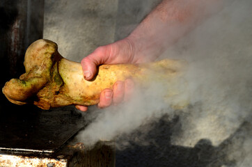 wizard man holding in his hand a strong old bone from an animal. it steams over the hot steam to...