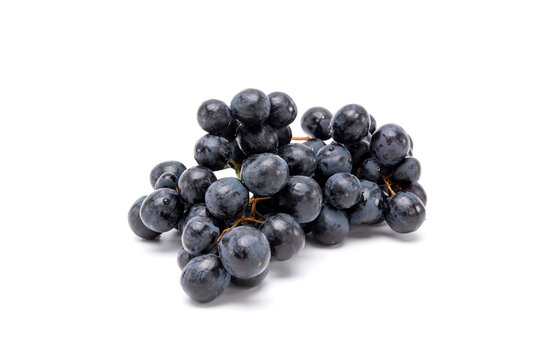 Bunch of organic black grapes isolated on white background