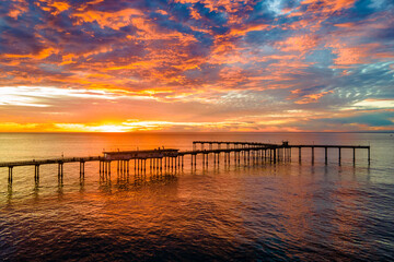 Fototapeta na wymiar Amazing colorful sunset over the Ocean Beach Fishing Pier