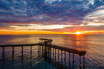Fototapeta na wymiar Amazing colorful sunset over the Ocean Beach Fishing Pier