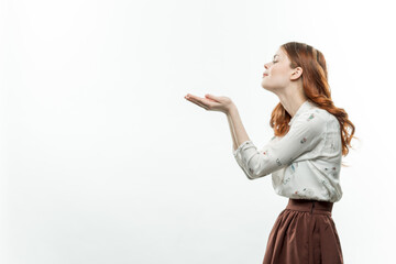 cheerful red-haired woman holding hands in front of her lifestyle Copy Space light background