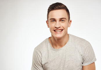 Cheerful handsome man gray t-shirt lifestyle cropped view