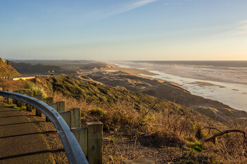 Fototapeta premium Coastline highway and the beginning of the dune area in Central Oregon in sunset