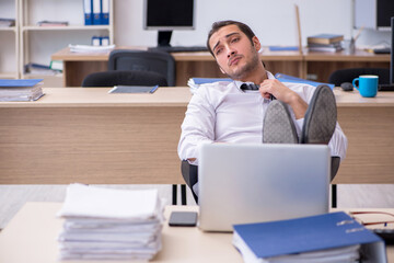 Young male employee unhappy with excessive work