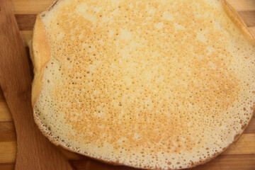 Stack of homemade pancakes on wood cooking board