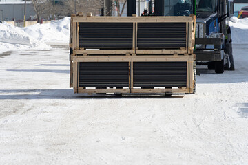 Consignment of crates delivered at customers warehouse using forklift
