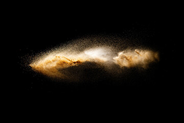 Fototapeta na wymiar Sand flying explosion isolated on black background. Freeze motion of sandy dust splash.