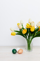 Easter holiday church traditions colorful eggs and yellow tulips