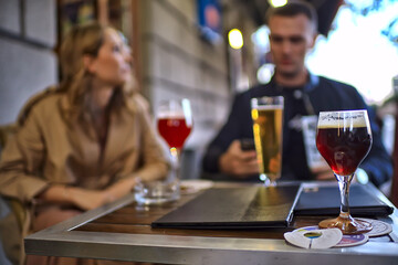 glasses of toast chin chin, hands with glasses of white wine in a street cafe