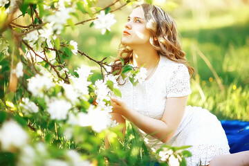 spring girl apple flowers, nature portrait of happy girl with long hair in blooming apple trees, freedom purity concept of happiness