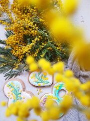glazed gingerbread cookies and a bouquet of mimosa