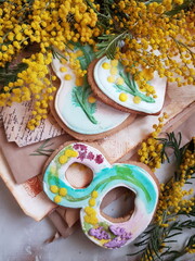 glazed gingerbread cookies and a bouquet of mimosa