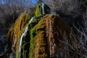 View of the colorful Dreimühlen waterfall in the Eifel